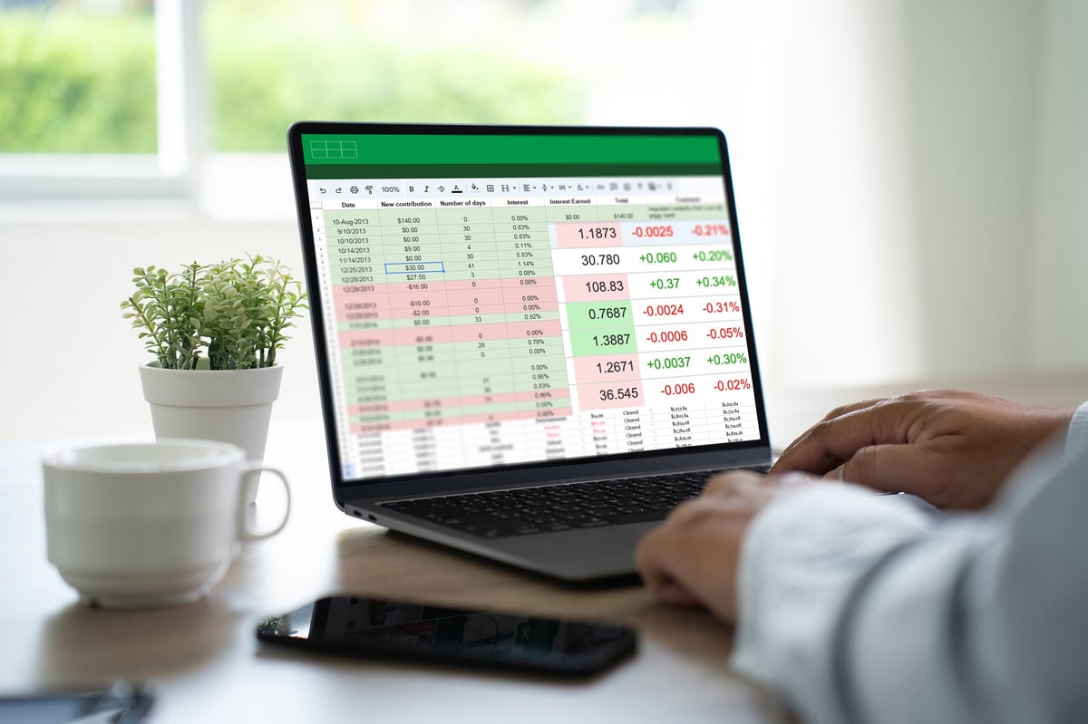 Businessman working with data and graphs in spreadsheet documents for online analysis and accounting