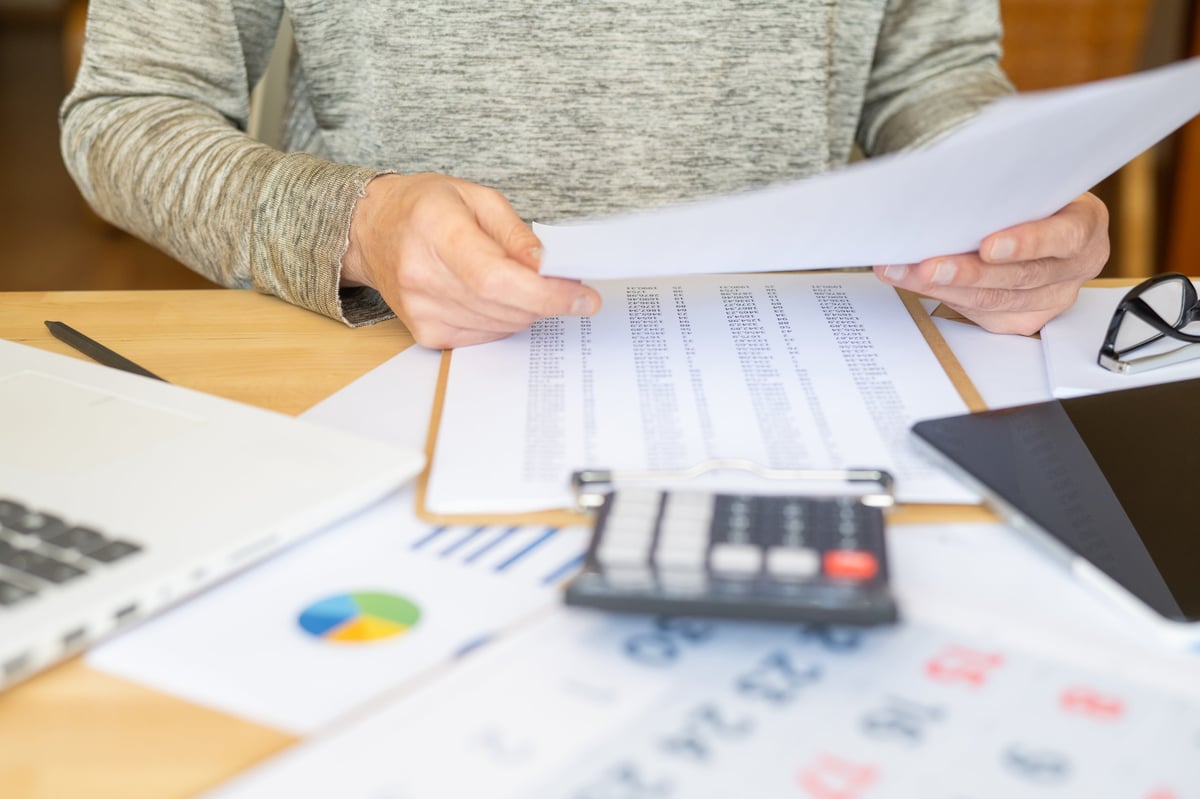 Businesswoman analyzing financial documents, organizing bills, setting budgets