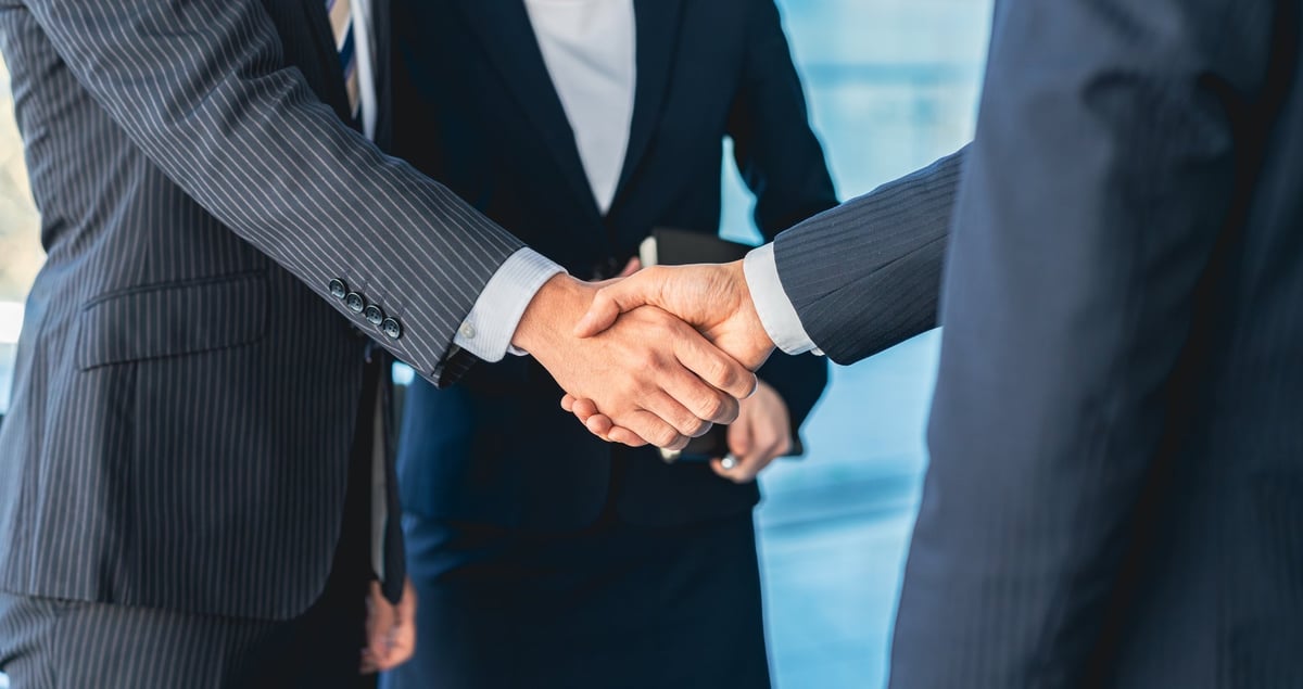 Business partners shaking hands on a commercial real estate deal