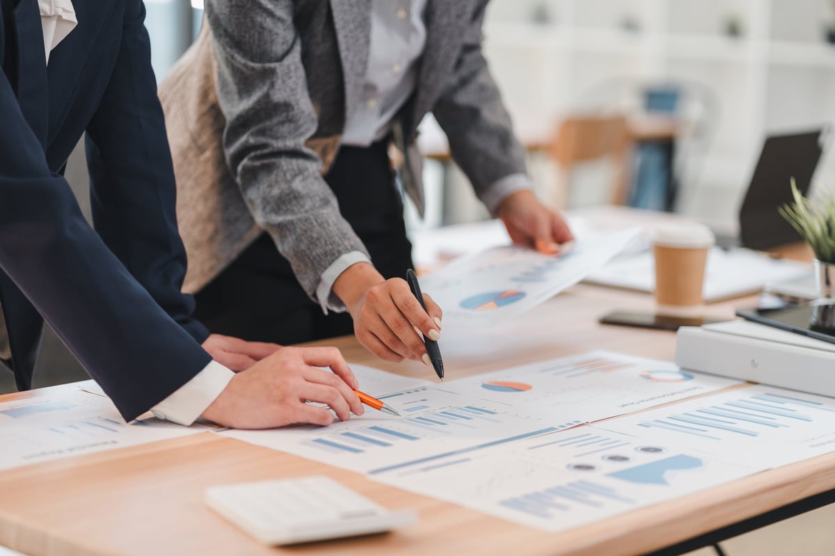 Investors reviewing commercial property financial projections at a desk