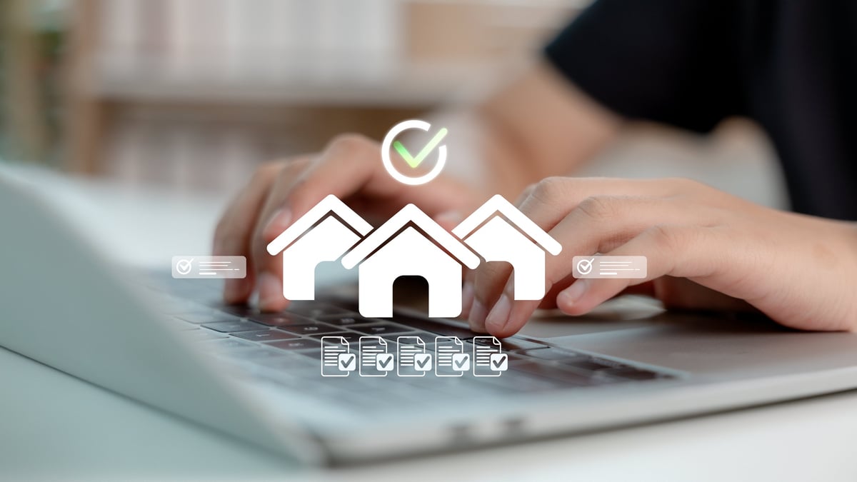 Hands typing on a laptop with virtual real estate icons, representing digital property investing and rental income analysis