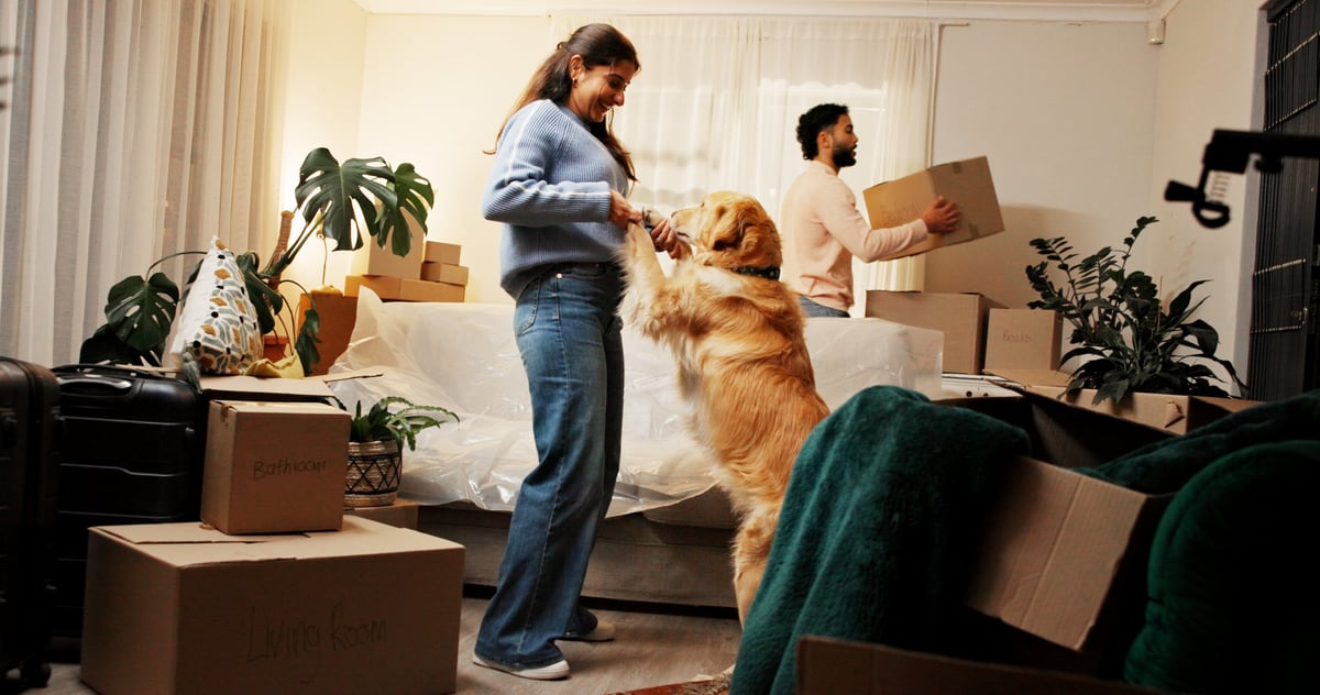 Smile, woman and dance with dog at new house for security, moving property and homeownership