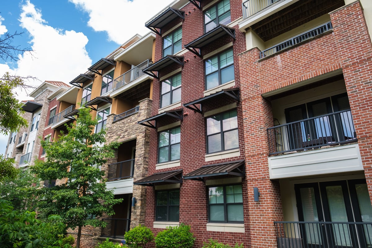 Brick facade apartment building complex representing a rental property portfolio