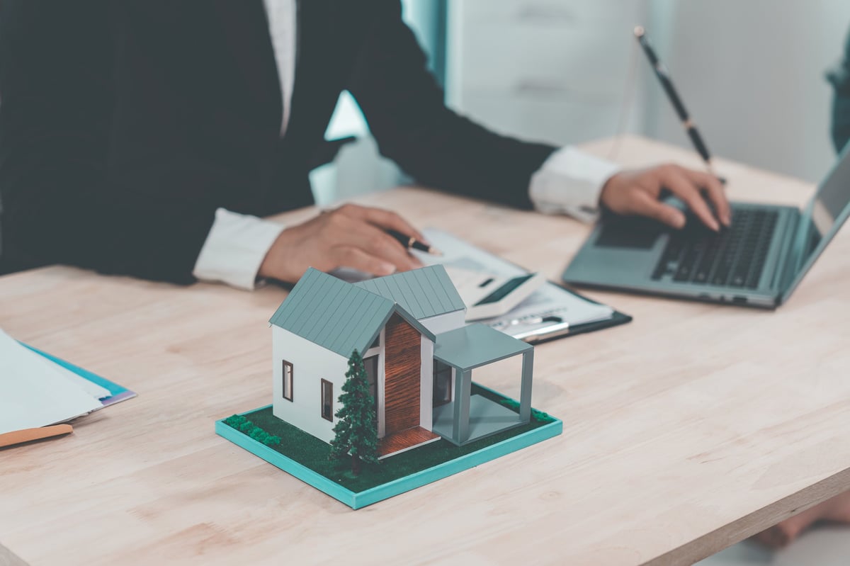 Real estate agent delivers model home to client, home insurance contract, home mortgage loan concept, real estate