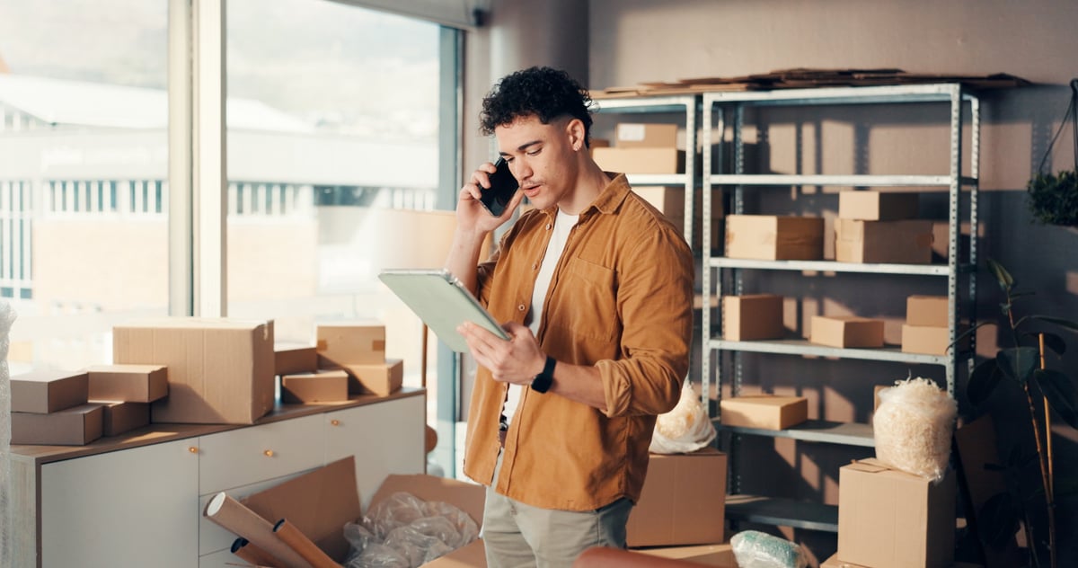 Man in office with boxes for online order, ecommerce communication