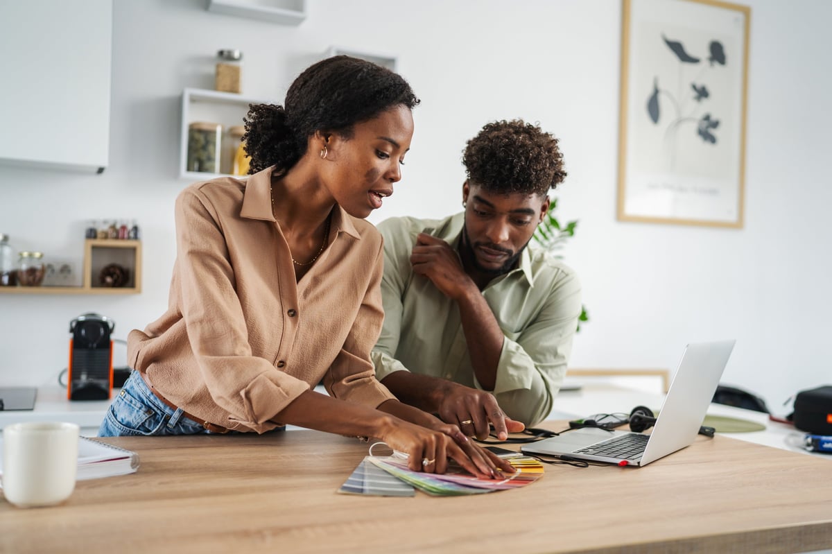 Couple comparing mortgage options at their kitchen counter