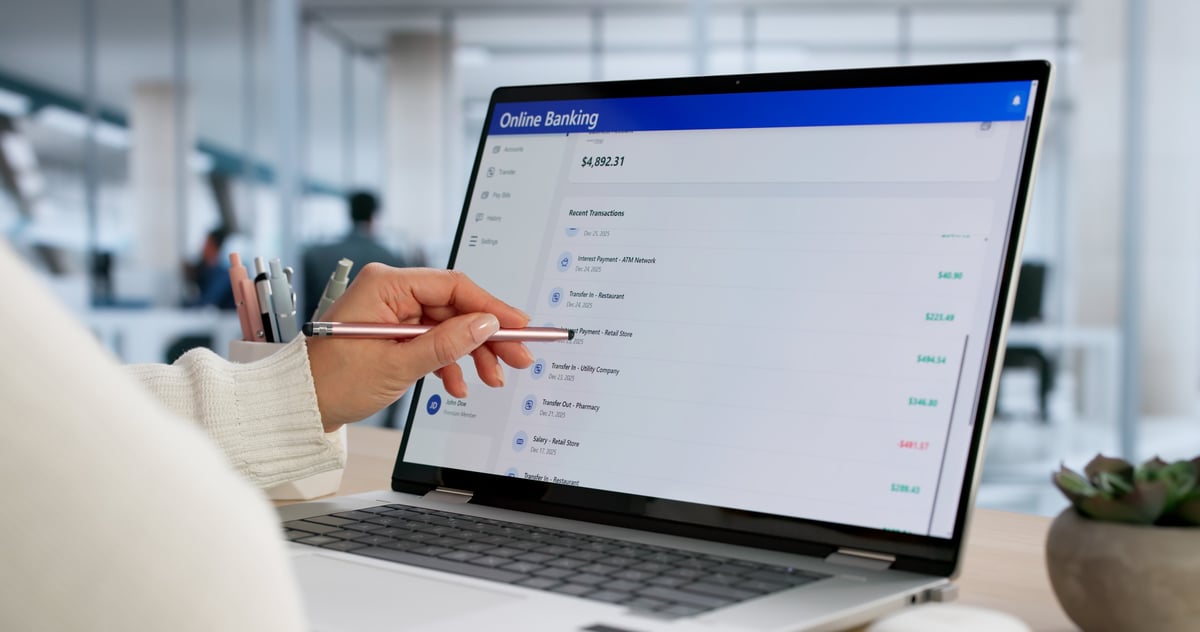 Successful young woman uses online bank app for secure transfer