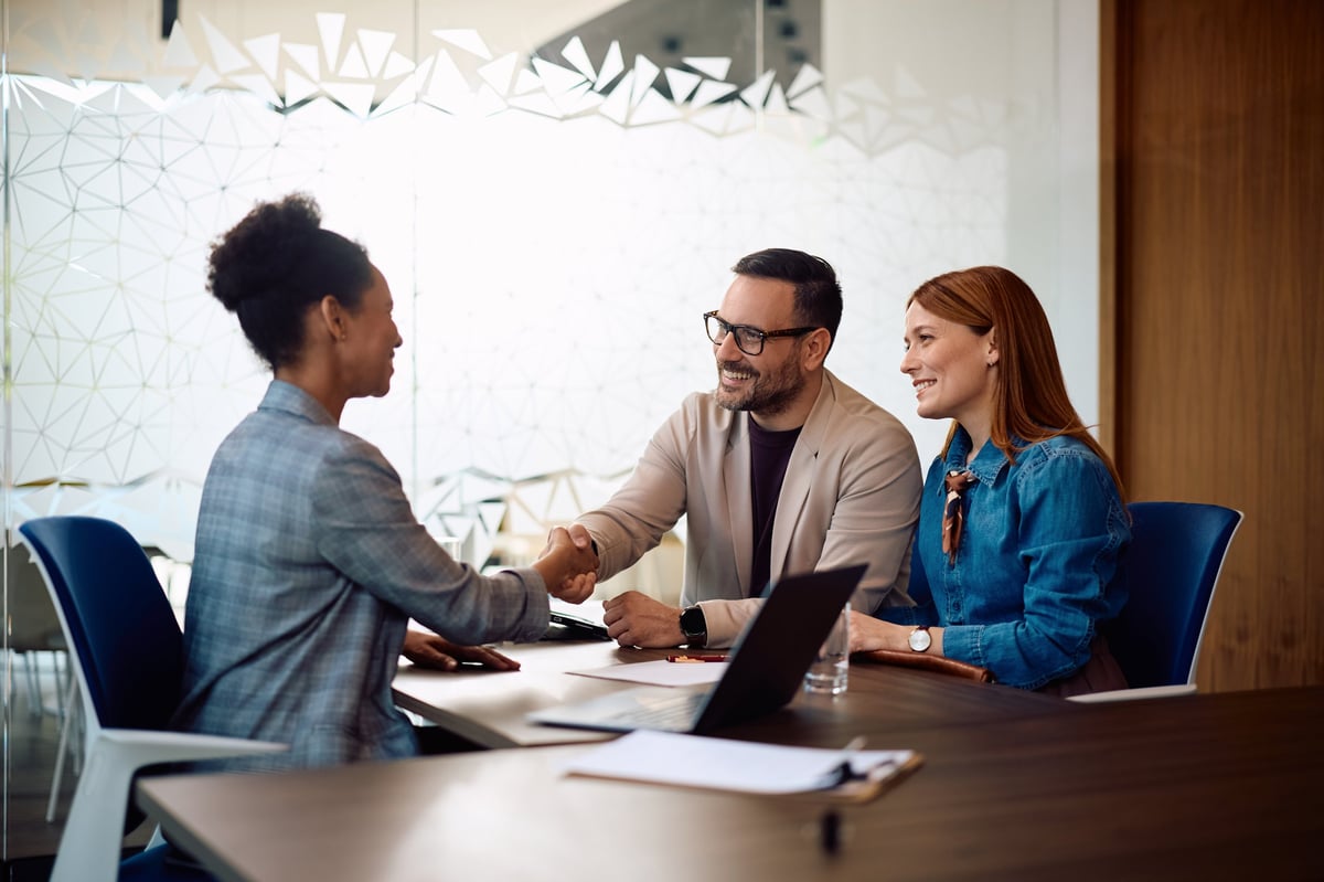 Couple meeting with a loan advisor at a desk