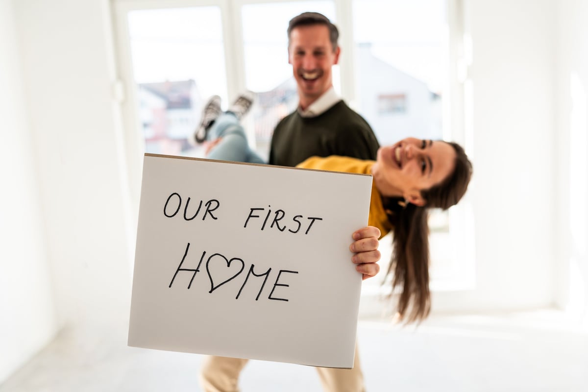 A joyful young couple celebrates moving into their first home