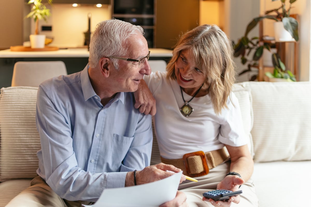 Senior couple calculating pensions and managing family finances at home