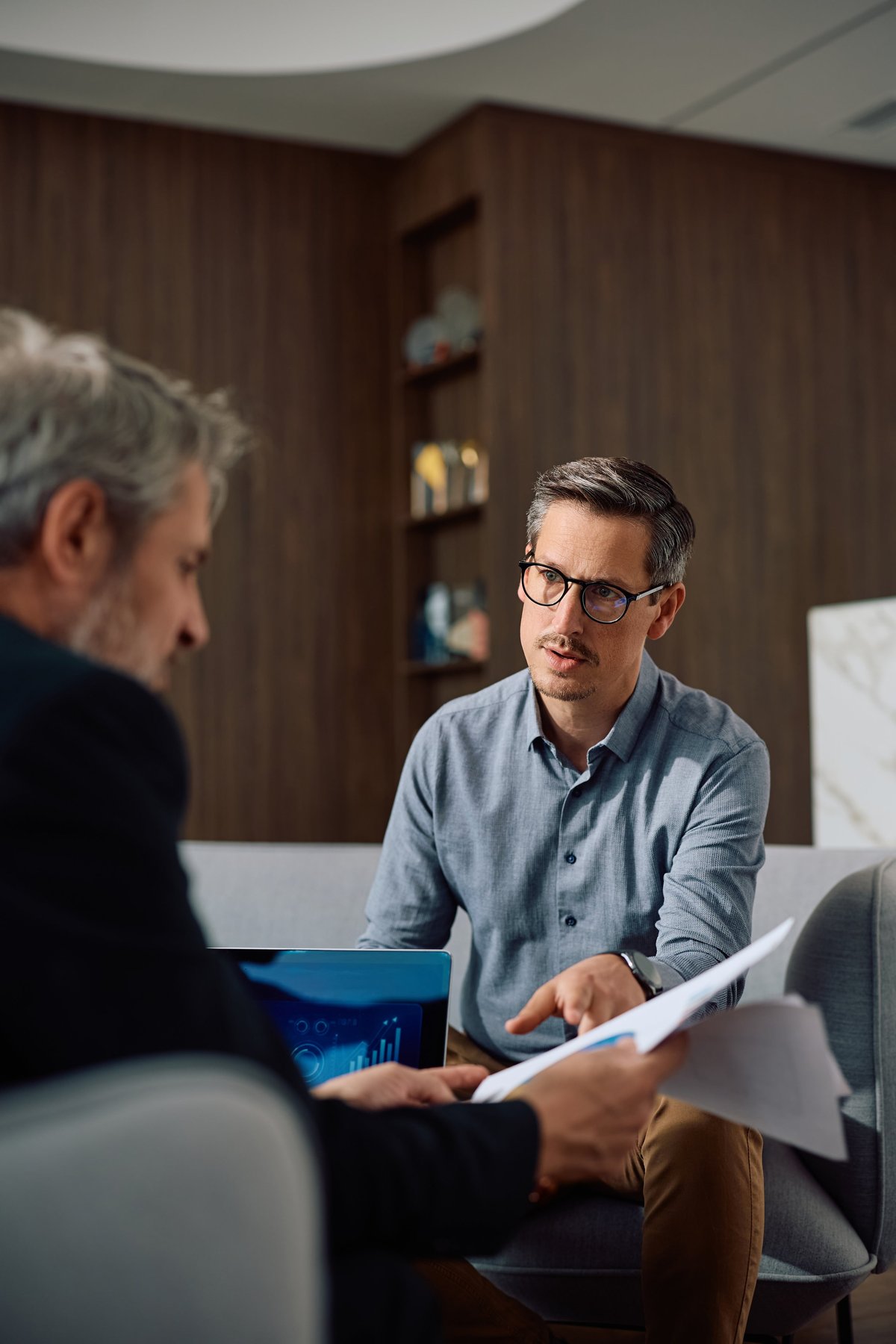 Business owners reviewing their company's profit and loss paperwork at an office table