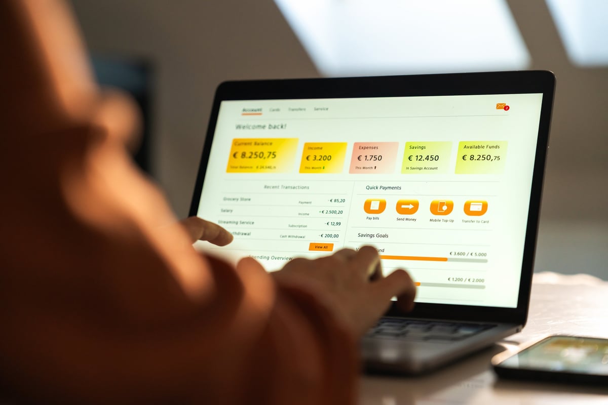 Close-up of person using online banking on laptop at home