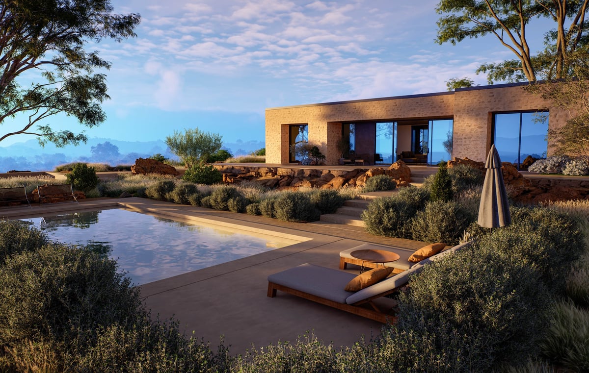 Contemporary stone villa with luxury swimming pool and desert landscaping under warm sunset sky in Arizona