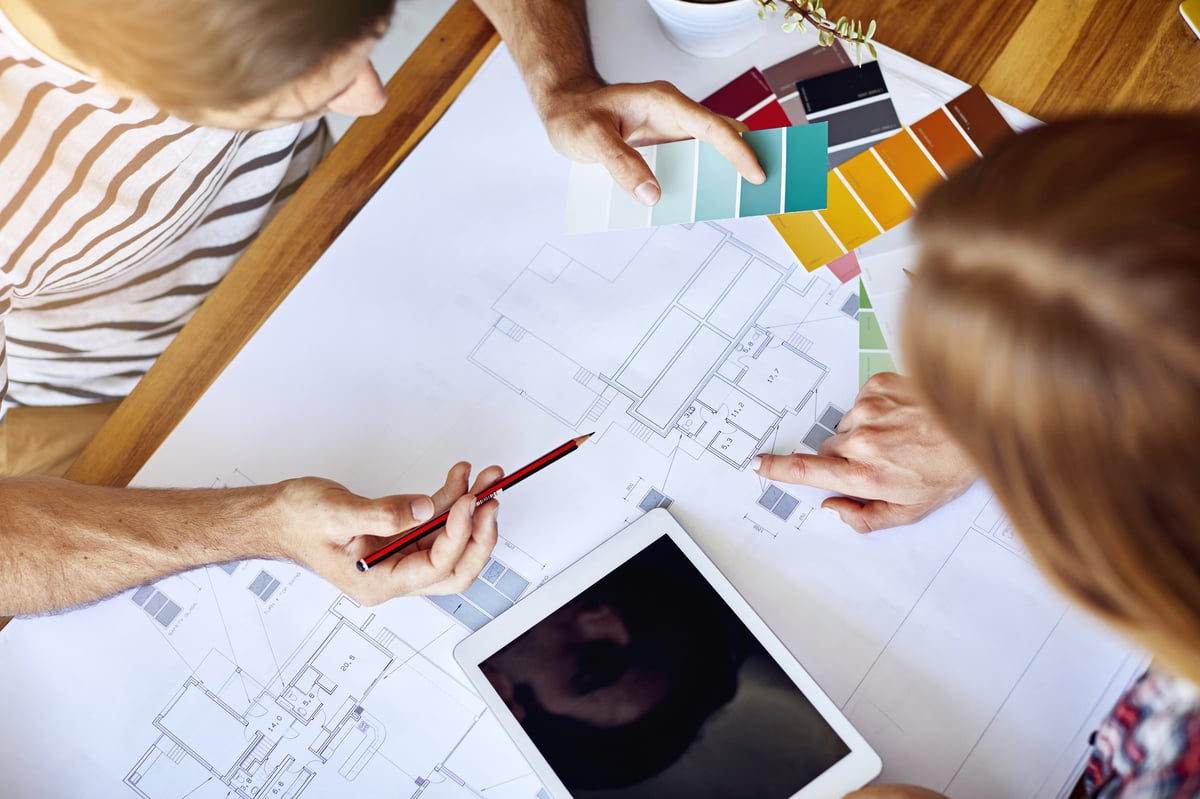 High angle shot of a couple discussing decor plans for their home