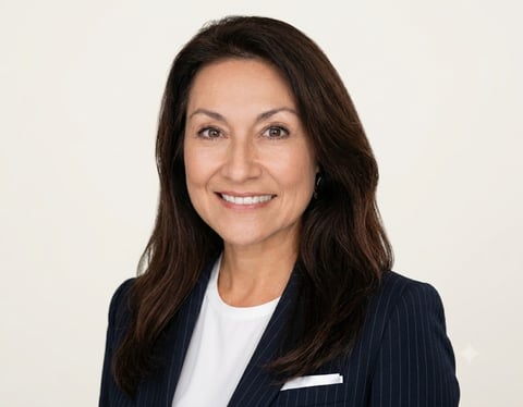 Professional headshot of a smiling woman with long dark hair wearing a navy pinstriped blazer and white top