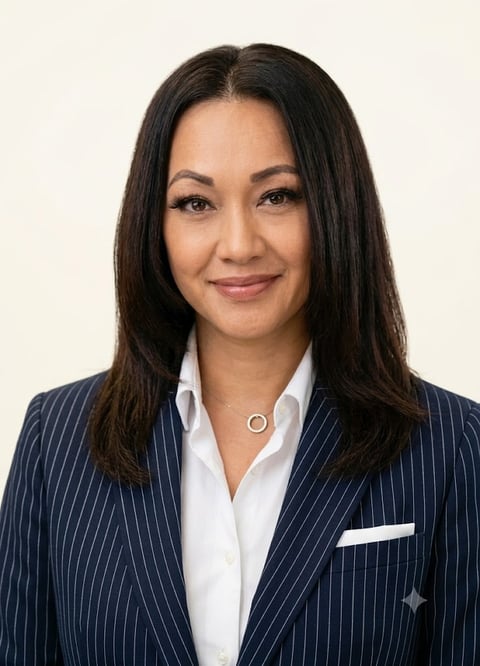 Professional headshot of an Asian woman with long dark hair wearing a navy pinstriped blazer and white collared shirt